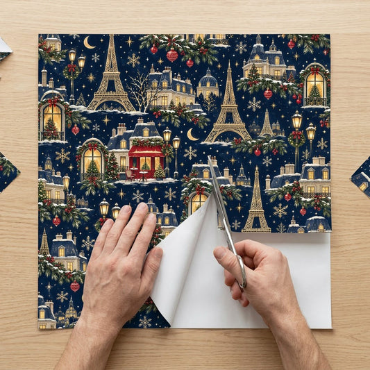 Navy Christmas wrapping paper with golden Eiffel Towers, Parisian buildings, a red cafe, stars, moons and snowflakes.