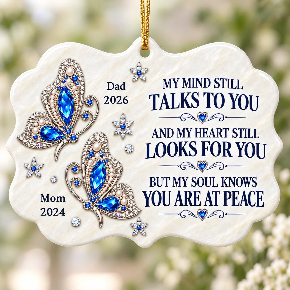 Scalloped ceramic ornament with two blue jeweled butterflies, silver starburst flowers and a memorial quote.
