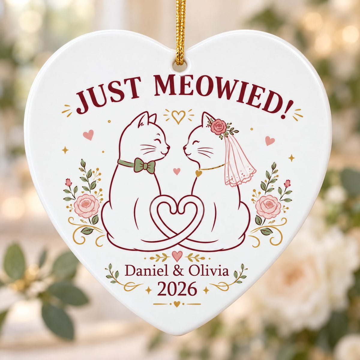 Two white cats with bow tie and bridal veil under JUST MEOWIED with roses and stars on a heart ceramic ornament.