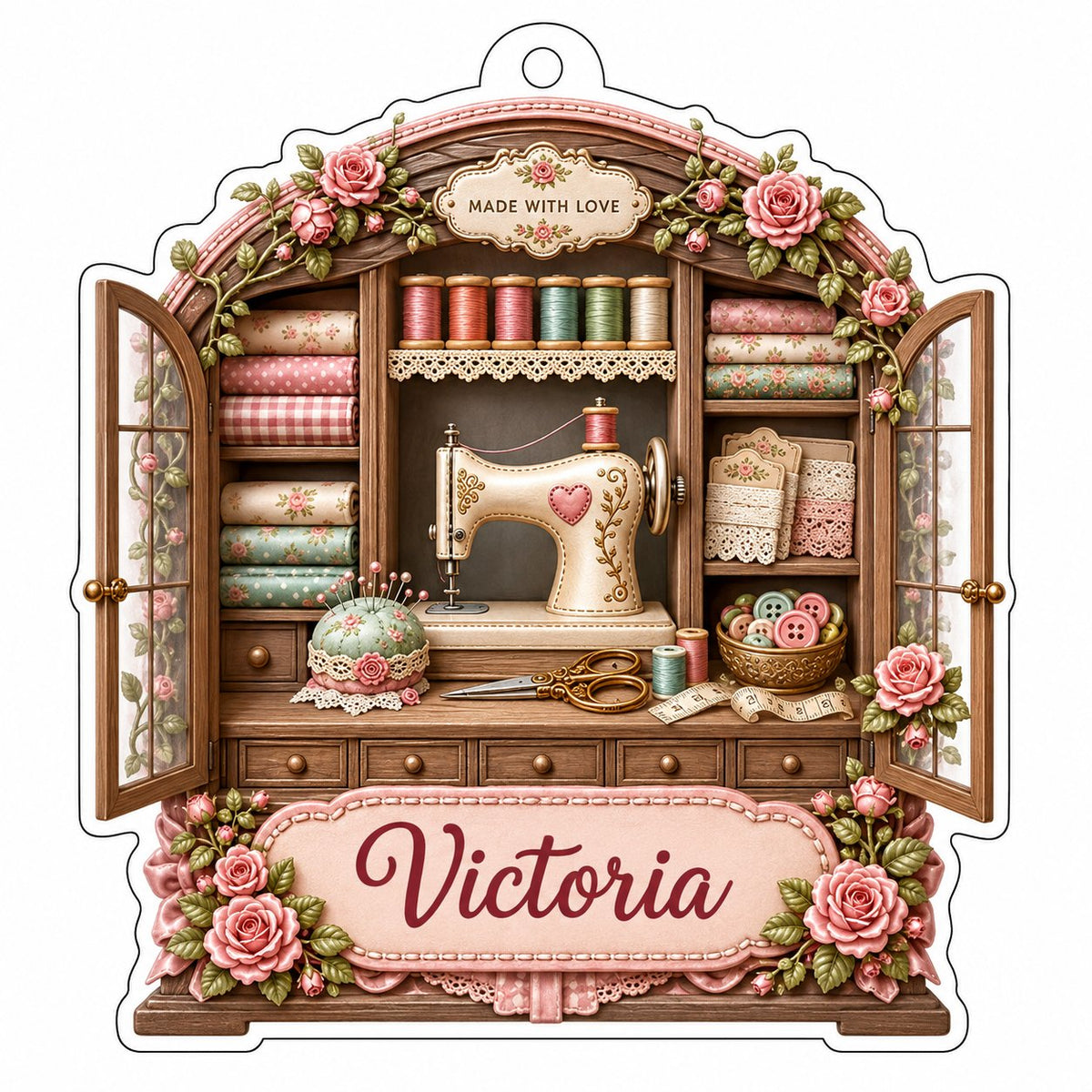 Acrylic ornament shaped like a sewing cabinet with roses, sewing machine, scissors and a pink name banner.