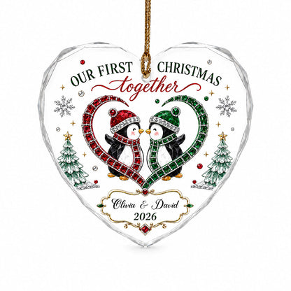 Heart-shaped stained glass suncatcher with two penguins in red and green scarves, jeweled trees, and silver snowflakes