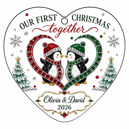 Heart-shaped stained glass suncatcher with two penguins in red and green scarves, jeweled trees, and silver snowflakes