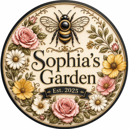 Round wooden sign with 'GRANDMA'S GARDEN', a gold-and-black bee, floral wreath, and EST. year on a light wood background
