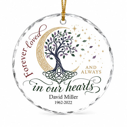 Round glass ornament with Celtic tree of life, gold crescent moon, stars, and phrase Forever loved in our hearts.