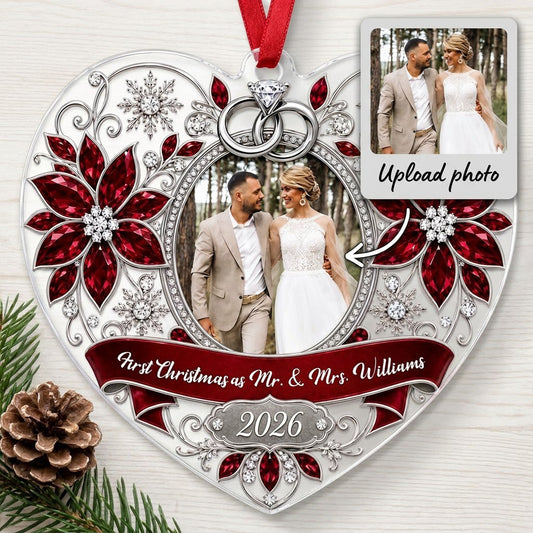 Heart acrylic ornament with couple photo, silver rings, poinsettias, and First Christmas as Mr. & Mrs. 2026.