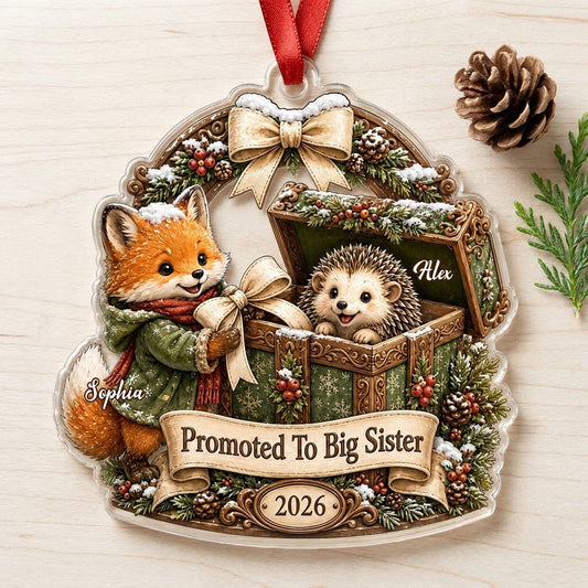 Custom-cut acrylic ornament: fox in jacket, hedgehog in box, pine arch and Promoted To Big Sister banner.