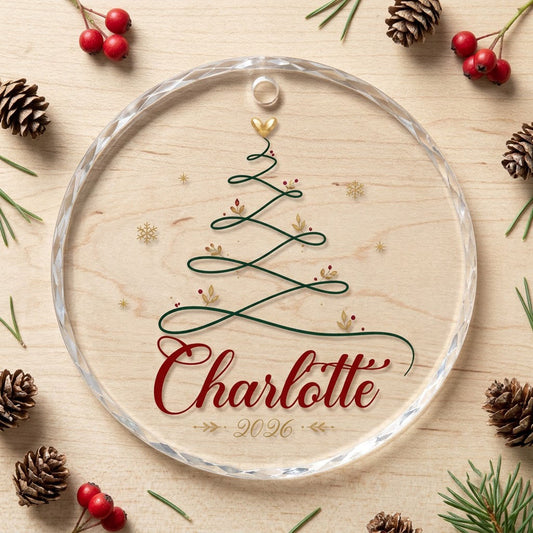 Clear round glass ornament with a looping green line Christmas tree topped by a small gold heart, name and year.