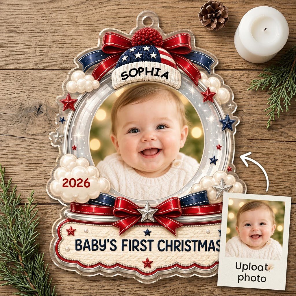 Custom-cut acrylic ornament with baby's photo, patriotic beanie, red bows, stars, and 'Baby's First Christmas' banner.