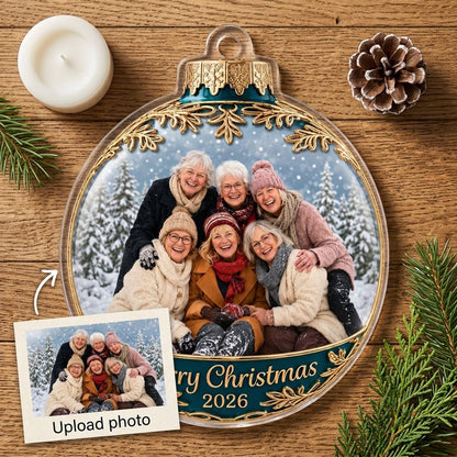 Clear acrylic bauble ornament with photo of six women in snowy pines, gold filigree, teal banner and Merry Christmas tex