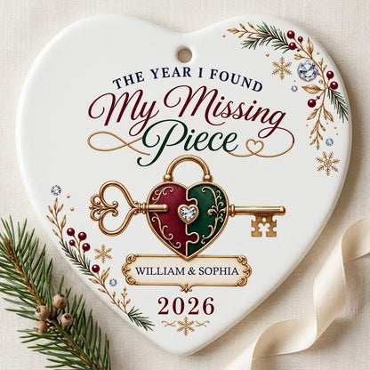 Heart ceramic ornament with a gold key through a burgundy and green heart lock, pine sprigs, berries, and gold snowflake