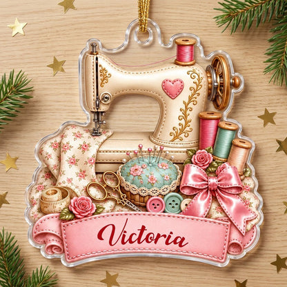 Custom-cut acrylic ornament with vintage cream sewing machine, pink banner, roses, thread spools and scissors.