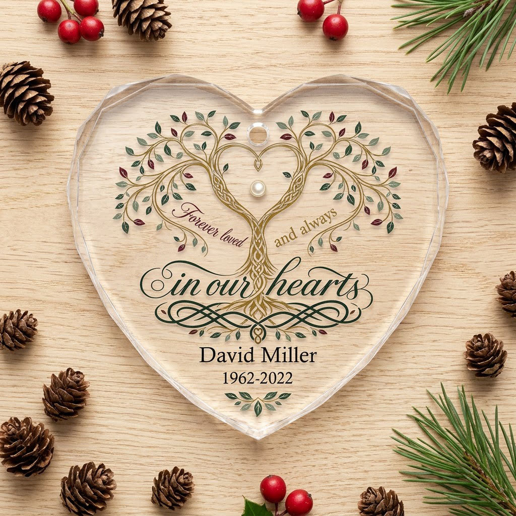 Heart glass ornament with a golden tree of life and the text 'Forever loved and always in our hearts'.