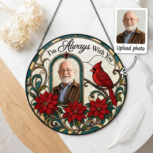 Round stained-glass style suncatcher with arched photo window, red cardinal, three red poinsettias and the words I'm Alw