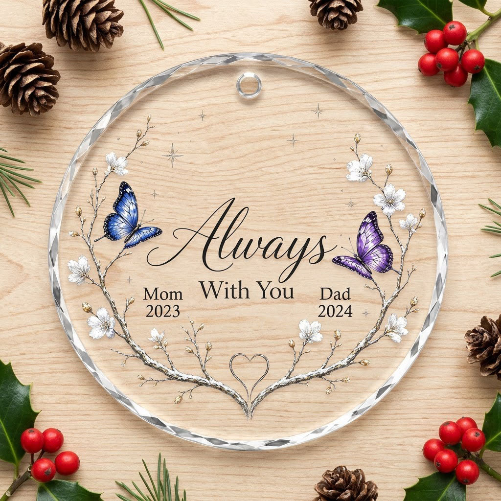 Round glass ornament with branch wreath, white blossoms, blue and purple butterflies, and Always With You text.
