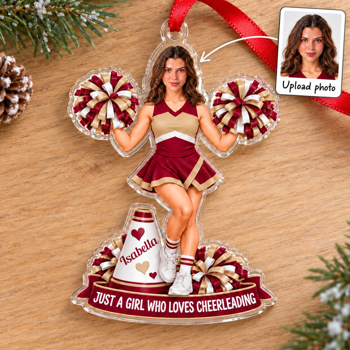 Custom-cut acrylic ornament of a maroon-and-gold cheerleader with pom-poms, megaphone, and a name banner.