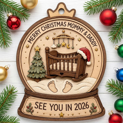 Snow globe wood ornament with crib, Santa hat, mobile, tree, footprints, and Merry Christmas Mommy & Daddy text.