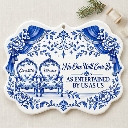 Blue-and-white ceramic ornament with theater masks, vintage chairs, Delft florals, and draped curtains.