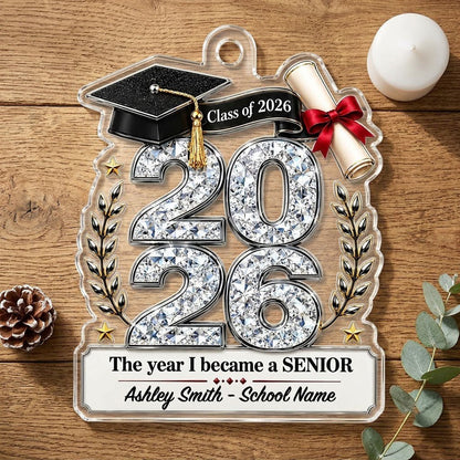 Custom-cut clear acrylic ornament shaped like a graduation cap with Class of 2026, diploma, laurels, and name plaque.