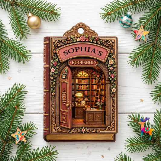 Ornament shaped like a vintage book with an open arched door into a glowing library and the words 'BOOKSHOP'.