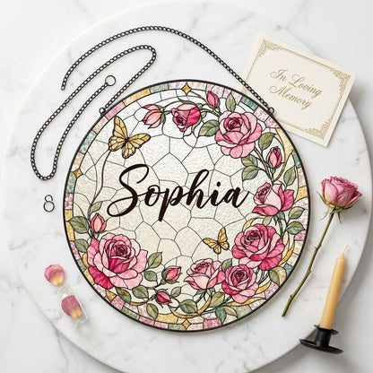 Round stained-glass style suncatcher with pink roses, two yellow butterflies, green leaves, and a decorative patterned b