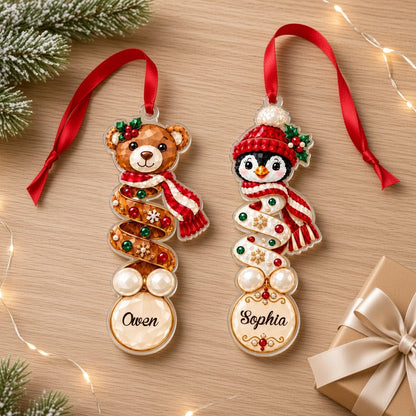 Clear acrylic ornament with a teddy bear or penguin in gem-detailed spiral style, personalized with names.