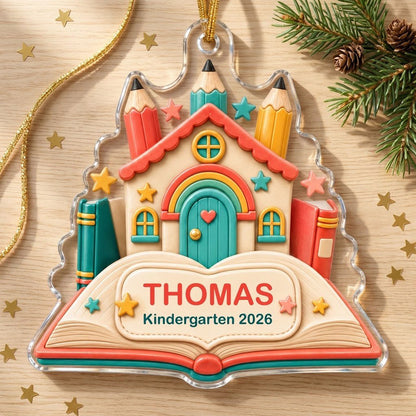 Clay-style schoolhouse on an open book with pencils and stars, personalized with child's name and Kindergarten 2026