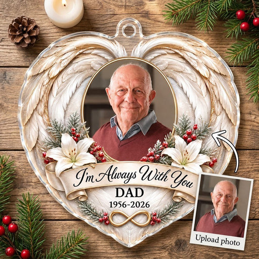 Heart-shaped acrylic ornament with angel wings, oval photo frame, white lilies, pine sprigs, red berries, and 'I'm Alway