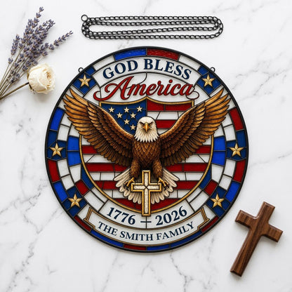 Round stained glass-look suncatcher with a bald eagle over a gold cross and an American flag shield with family name.