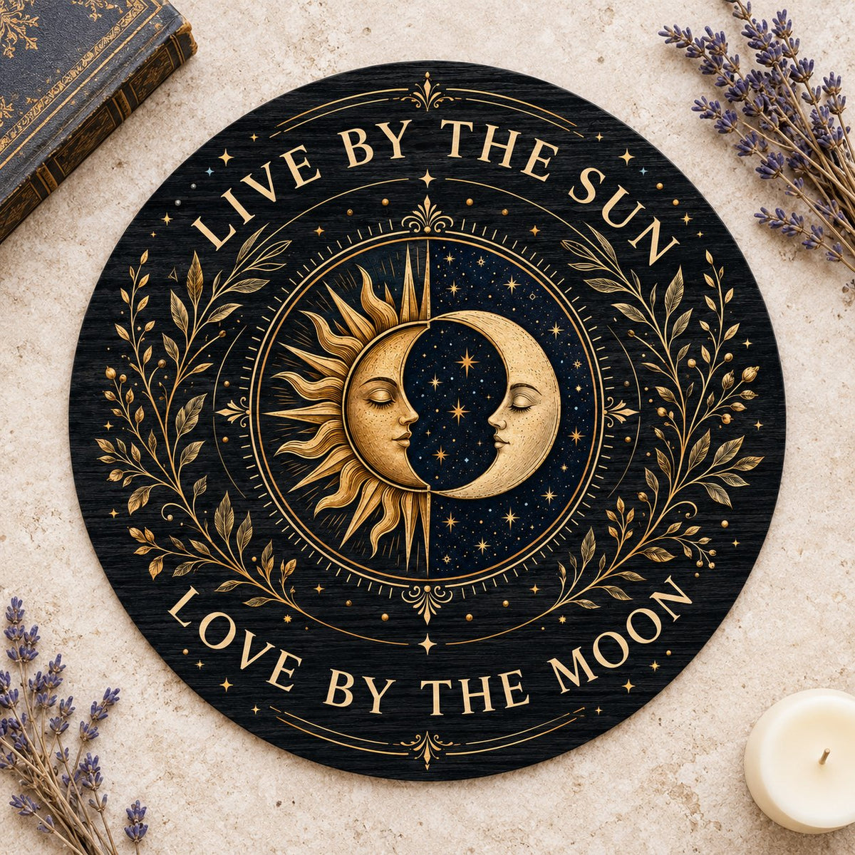 Round wooden sign with gold sun and crescent moon faces and the words “Live By The Sun, Love By The Moon”.