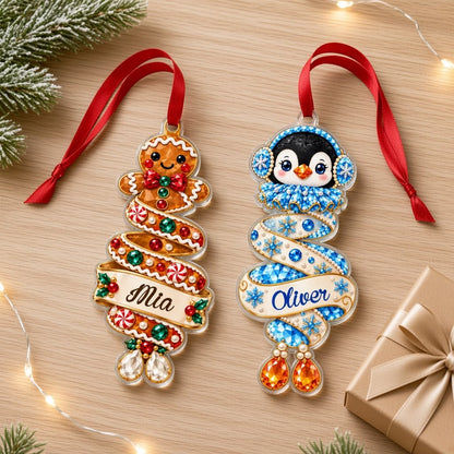 Custom-cut acrylic ornament with a gingerbread man or penguin on spiraling ribbons with a scroll name banner