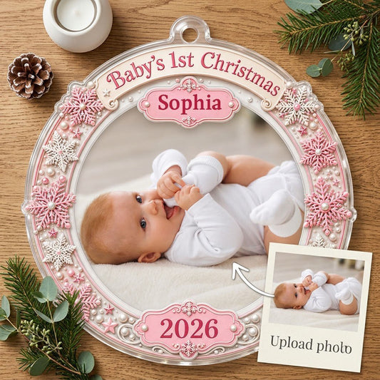 Round acrylic ornament with pink and white snowflakes framing a baby photo and the words Baby's 1st Christmas.