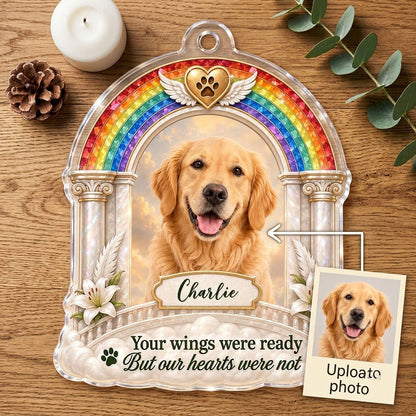 A rainbow arch pet memorial acrylic ornament with a winged golden heart, paw print, lilies, pillars, clouds and a photo 