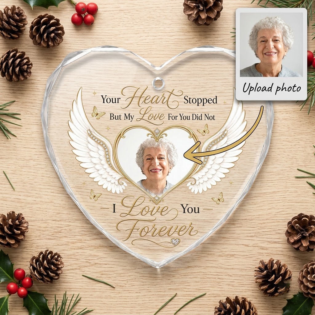 Heart-shaped glass ornament with white angel wings, gold heart photo frame, golden butterflies and sparkles.