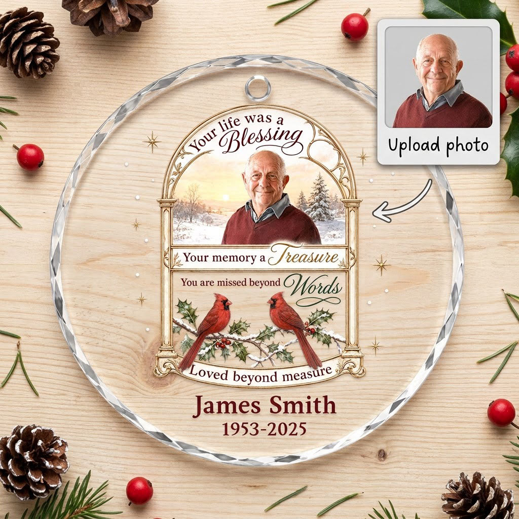 Round glass ornament with golden arched photo frame, two red cardinals on snowy pine and a memorial quote.
