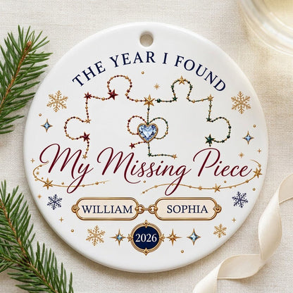 Round white ceramic ornament with interlocking red and green jeweled puzzle pieces, blue heart gem, names and year