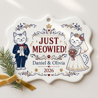 Medallion ceramic ornament with cat bride and groom, gold crown, floral scrolls, red hearts and paw prints on white.