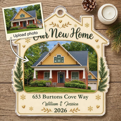House-shaped acrylic ornament with “Our New Home”, a house photo frame, pine boughs, gold hearts and snowflakes.