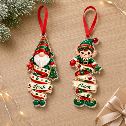 Clear acrylic ornaments shaped like a Christmas gnome and elf in red and green, each personalized with a name.