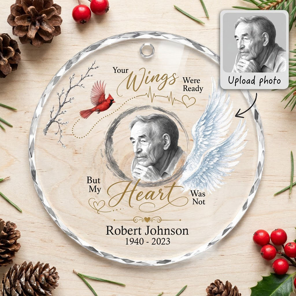 Round glass ornament with a sketch portrait frame, blue angel wing, red cardinal and 'Your Wings Were Ready' memorial te