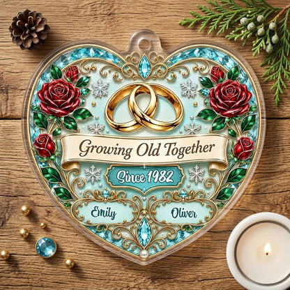 Heart-shaped clear acrylic ornament with golden rings, red roses, “Growing Old Together,” and custom names with a since 