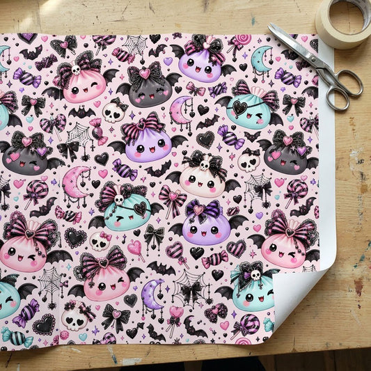 Pastel goth Halloween wrapping paper with cute bat-winged characters, skulls, moons, bows and candies.