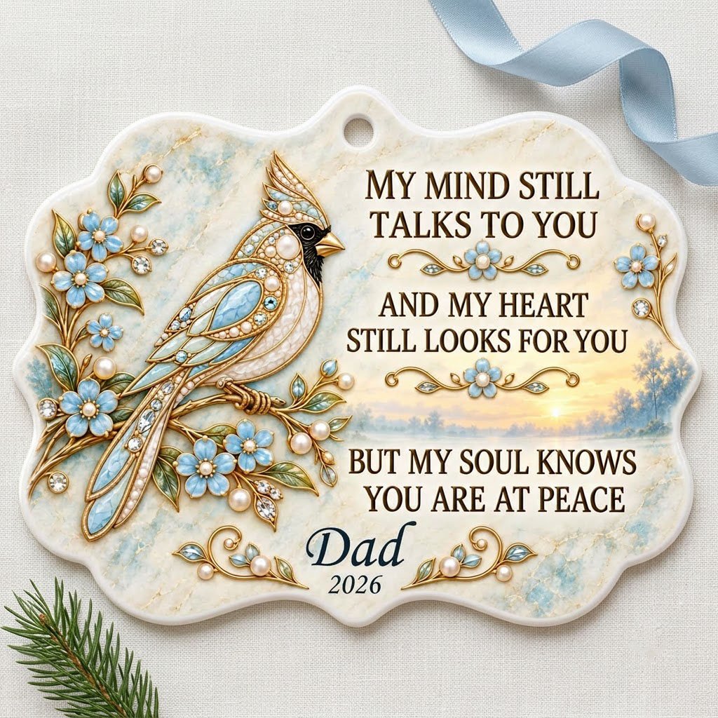 Ceramic medallion ornament with a jewel-encrusted blue bird, blue flowers, gold filigree, and a sunrise lake background.