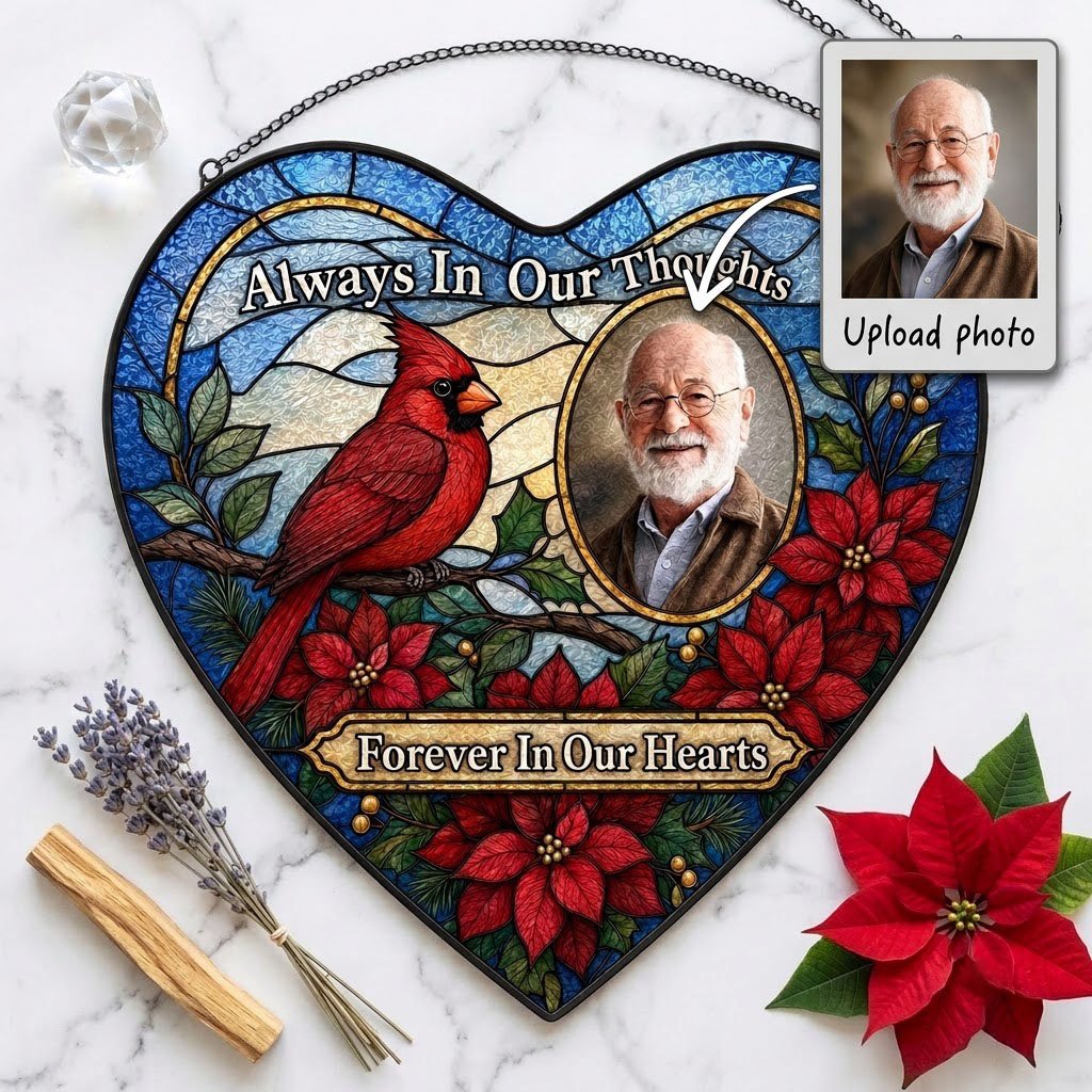Heart stained glass suncatcher with red cardinal, oval memorial photo frame, and red poinsettias with green leaves.