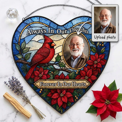 Heart stained glass suncatcher with red cardinal, oval memorial photo frame, and red poinsettias with green leaves.