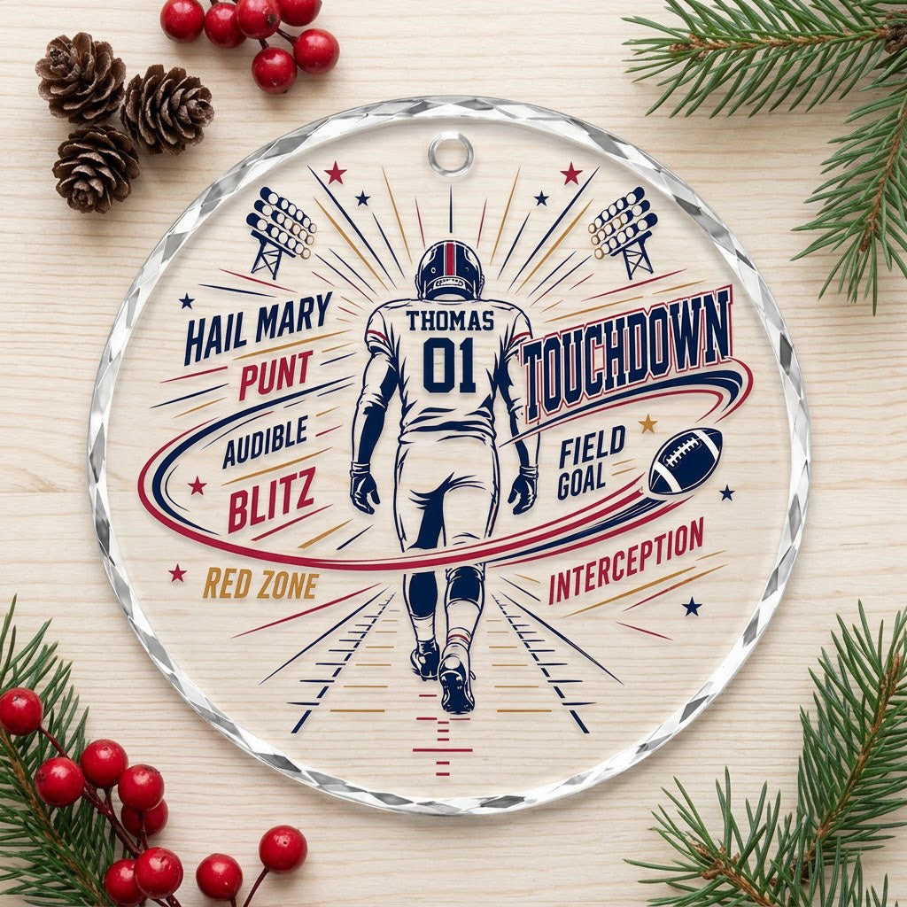 Round faceted glass ornament with football player back view, stadium lights, navy swoosh, and name and number.