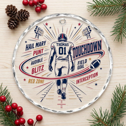 Round faceted glass ornament with football player back view, stadium lights, navy swoosh, and name and number.