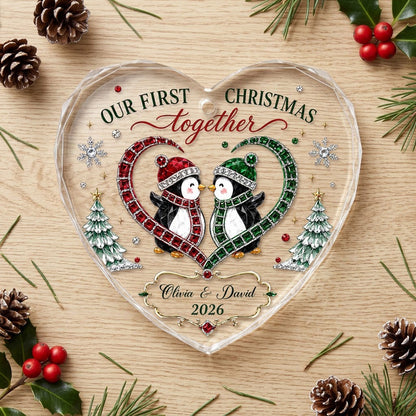 Heart-shaped stained glass suncatcher with two penguins in red and green scarves, jeweled trees, and silver snowflakes