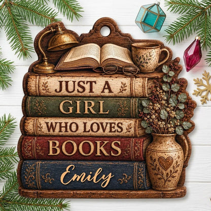 Bookshelf-shaped wood ornament with lamp, open book, teacup, vase, and Just a Girl Who Loves Books text.