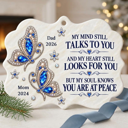 Scalloped ceramic ornament with two blue jeweled butterflies, silver starburst flowers and a memorial quote.