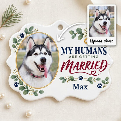 Scalloped medallion ornament with dog photo, eucalyptus, paw prints, and 'MY HUMANS ARE GETTING MARRIED' text.